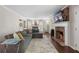 Bright living room featuring a brick fireplace, hardwood floors, and a comfortable sectional sofa at 105 Woodmeade Nw Way, Marietta, GA 30064