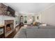 Comfortable living room featuring a brick fireplace, hardwood floors, and a spacious sectional sofa at 105 Woodmeade Nw Way, Marietta, GA 30064