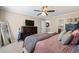 A well-lit main bedroom offering a comfortable setting, ceiling fan, and dresser at 105 Woodmeade Nw Way, Marietta, GA 30064
