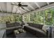 Inviting screened-in porch with wicker seating, ceiling fan, and serene backyard views at 105 Woodmeade Nw Way, Marietta, GA 30064