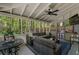 Spacious screened-in porch with wicker seating, ceiling fan, and ample space for entertaining at 105 Woodmeade Nw Way, Marietta, GA 30064