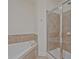 Bathroom with soaking tub and glass enclosed shower with tiled walls at 1971 Sterling Oaks Cir, Brookhaven, GA 30319