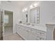 Double sink bathroom vanity with white cabinets and plenty of storage space at 1971 Sterling Oaks Cir, Brookhaven, GA 30319