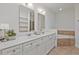 Bathroom featuring double sink vanity with quartz countertop and separate tub at 1971 Sterling Oaks Cir, Brookhaven, GA 30319