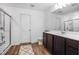 The bathroom boasts wood-look floors, a glass shower, and a vanity with a dark cabinet at 4740 Alford Commons, Cumming, GA 30028