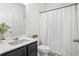 This bathroom features a single sink vanity with a white countertop and a shower with a white curtain at 4740 Alford Commons, Cumming, GA 30028