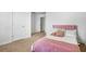 Cozy bedroom with pink accents, plush bedding, and neutral carpeting at 4740 Alford Commons, Cumming, GA 30028