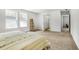 A spacious bedroom with large windows, neutral carpet, and a view into the bathroom and hallway at 4740 Alford Commons, Cumming, GA 30028