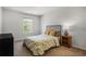 Bright carpeted bedroom with window and black metal bed frame at 4740 Alford Commons, Cumming, GA 30028