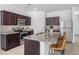 Modern kitchen with stainless steel appliances, granite countertops, and dark wood cabinets at 4740 Alford Commons, Cumming, GA 30028