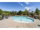 Community pool with ample seating surrounded by lush landscaping at 4740 Alford Commons, Cumming, GA 30028