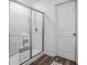 This bathroom features a glass shower with a chrome shower head and a glass door with a chrome handle at 4740 Alford Commons, Cumming, GA 30028