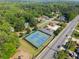 Aerial view featuring a neighborhood pool, community tennis courts, and lush landscape at 744 Edgewater Nw Ln, Kennesaw, GA 30144