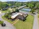 Stunning aerial view of the property, highlighting the pool, well-manicured lawn, and nearby tennis courts at 744 Edgewater Nw Ln, Kennesaw, GA 30144