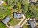 Overhead view of a gray roofed home surrounded by verdant trees and a winding driveway at 744 Edgewater Nw Ln, Kennesaw, GA 30144