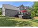 Exterior view of the home showcasing a spacious deck with a red umbrella at 744 Edgewater Nw Ln, Kennesaw, GA 30144