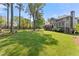 Large backyard with mature trees, lush lawn, and a view of the house at 744 Edgewater Nw Ln, Kennesaw, GA 30144