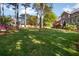 Expansive backyard featuring lush green grass, mature trees, and a deck, perfect for outdoor living and entertaining at 744 Edgewater Nw Ln, Kennesaw, GA 30144