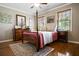 Cozy bedroom featuring hardwood floors, a patterned rug, and natural lighting at 744 Edgewater Nw Ln, Kennesaw, GA 30144