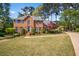 Charming two-story brick home featuring manicured lawn and beautiful landscaping at 744 Edgewater Nw Ln, Kennesaw, GA 30144