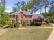 Beautiful brick home with a well-manicured lawn and professional landscaping at 744 Edgewater Nw Ln, Kennesaw, GA 30144