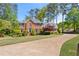 Charming brick home with lush green lawn, mature trees, and a long driveway at 744 Edgewater Nw Ln, Kennesaw, GA 30144