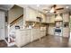 Spacious kitchen with stainless appliances and bright cabinets near the staircase at 744 Edgewater Nw Ln, Kennesaw, GA 30144