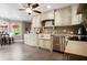 Bright kitchen features custom cabinets, stainless appliances and stone tile flooring at 744 Edgewater Nw Ln, Kennesaw, GA 30144