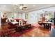 Open living room with fireplace, hardwood floors, and access to sunroom at 744 Edgewater Nw Ln, Kennesaw, GA 30144