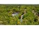 A wide aerial view of a community featuring a clubhouse, tennis courts, and houses surrounded by trees at 815 Connell Ln, Lawrenceville, GA 30044