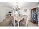 Formal dining room featuring elegant chandelier, large window, and access to the living area at 815 Connell Ln, Lawrenceville, GA 30044
