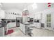 Bright and spacious kitchen with stainless appliances, tile floors, white cabinets, and a center island at 815 Connell Ln, Lawrenceville, GA 30044