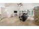 Spacious living room features a fireplace, ceiling fan, neutral carpet, and access to back yard at 815 Connell Ln, Lawrenceville, GA 30044