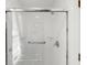 Shower featuring sliding glass door with handrails and built in shelving at 815 Connell Ln, Lawrenceville, GA 30044