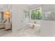 Serene bathroom with freestanding tub, marble tile, and a view into the main bedroom at 329 Mont Harmony Sw Rd, Powder Springs, GA 30127