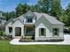 Charming home featuring a white brick facade, wood accents, manicured landscaping, and a welcoming entrance at 329 Mont Harmony Sw Rd, Powder Springs, GA 30127