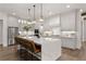 Bright, open kitchen featuring a large island with seating, stainless steel appliances, and pendant lighting at 329 Mont Harmony Sw Rd, Powder Springs, GA 30127