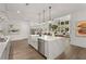 Bright open-concept kitchen featuring a large island, stainless steel appliances, and hardwood floors at 329 Mont Harmony Sw Rd, Powder Springs, GA 30127