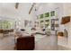 Elegant living room featuring high ceilings, large windows, a cozy fireplace, and stylish decor at 329 Mont Harmony Sw Rd, Powder Springs, GA 30127