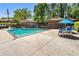 Community pool area featuring an umbrella-covered table and chairs, and multiple lounge chairs at 4282 Roswell Ne Rd # C3, Atlanta, GA 30342