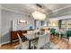 A dining room featuring a chandelier, view to the living room, and seating for six around a glass table at 6900 Roswell Rd # Q26, Atlanta, GA 30328