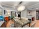 A dining area features a modern chandelier, view to the living room, and a glass-top table with seating at 6900 Roswell Rd # Q26, Atlanta, GA 30328