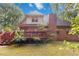 Home's backyard featuring a deck and lush landscaping at 219 Garden W Walk, Hampton, GA 30228
