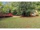 Large grassy backyard with a storage shed and deck at 219 Garden W Walk, Hampton, GA 30228