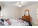 Simple bedroom with neutral walls, wood dresser and ceiling fan at 219 Garden W Walk, Hampton, GA 30228