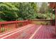Back deck surrounded by mature trees for a relaxing backyard experience at 219 Garden W Walk, Hampton, GA 30228