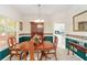 Formal dining room featuring traditional furniture, elegant wallpaper, and natural light at 219 Garden W Walk, Hampton, GA 30228