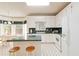 Bright kitchen featuring white cabinets, granite countertops, and breakfast nook with lots of natural light at 219 Garden W Walk, Hampton, GA 30228