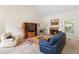 Cozy living room with brick fireplace, large built-ins, and lots of natural light at 219 Garden W Walk, Hampton, GA 30228