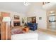 Bright living room with brick fireplace, vaulted ceiling, and view into the dining room at 219 Garden W Walk, Hampton, GA 30228
